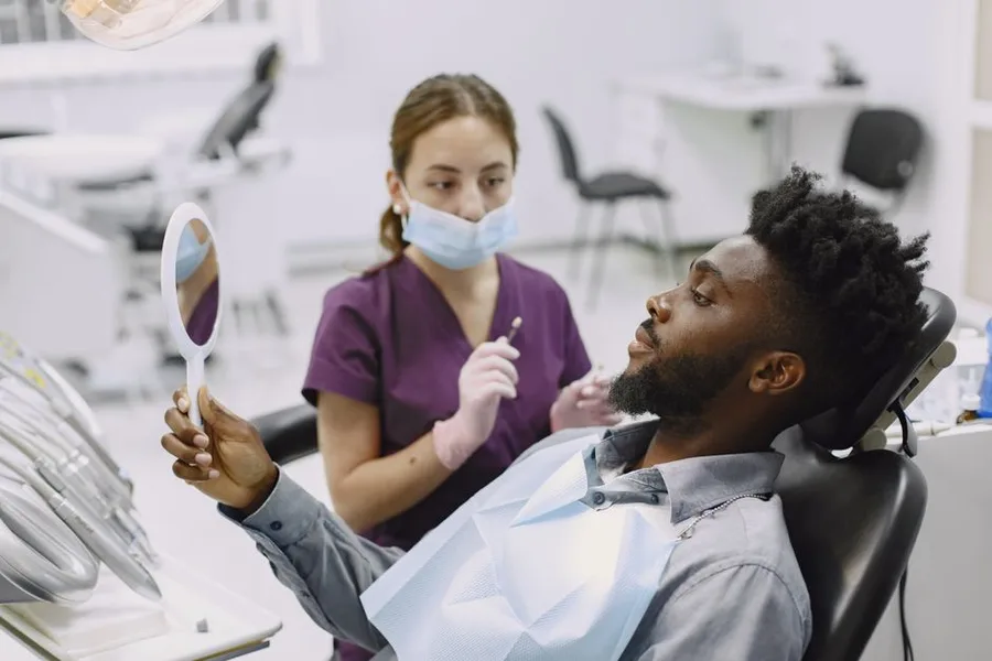 Gentle dental exam with a hand mirror at the Fort Myers office