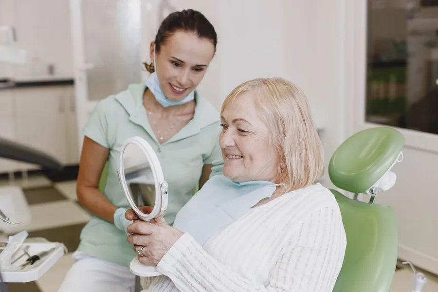 Patient smiling after a denture fitting in Fort Myers