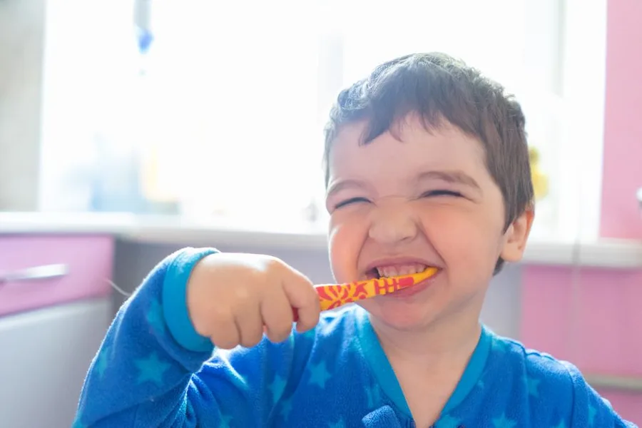 McGregor child smiling while brushing, patient of the Fort Myers family dentist